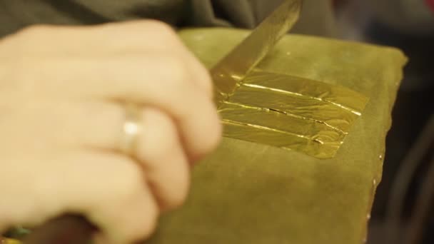 Artist Cuts Gold Leaf Special Knife Pieces Apply Oil Painting — Stock Video