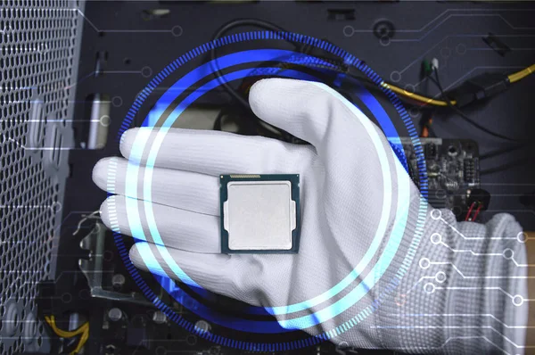Picture of a hand wearing white gloves with a CPU chip placed on it.
