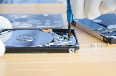 mechanic repairing hard drive, hard drive It is a device for storing data.