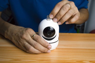 Conceptual man operating ip camera