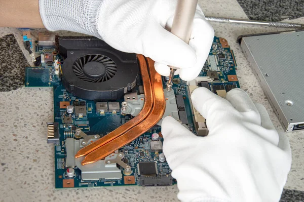 image of a mechanic repairing computer motherboard, electronic motherboard repair