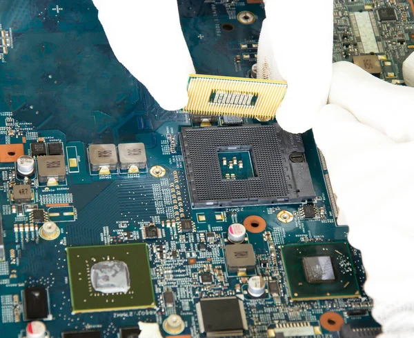 image of a mechanic repairing computer motherboard, electronic motherboard repair