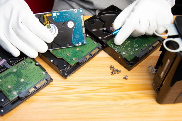 technician is repairing hard drive, hard drive used to store data