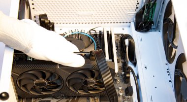 Technician repairing computer, installing video card