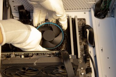 Technician repairing computer, installing CPU