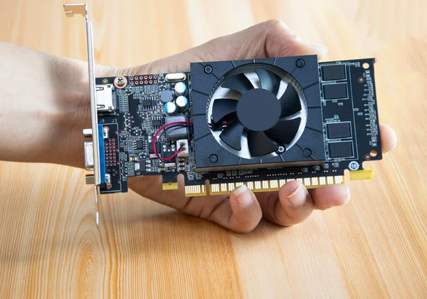 side view of computer graphics card holding in hand