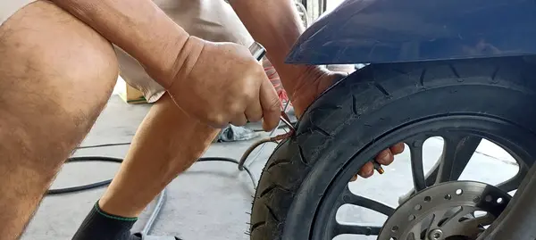 Technician patching a tire motorcycle tires