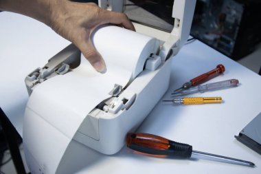 Top view. Technician repairing printer, label printer.	