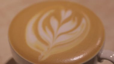 a cup of cappuccino in white cup, close up view