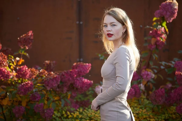 stock image fashion woman in dress with red lips posing in the garden