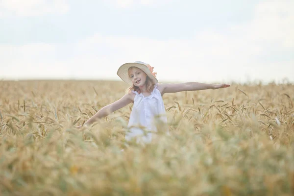 麦畑に立つ帽子の幸せな女の子の肖像画 — ストック写真