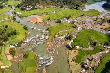 Aerial landscape in Quay Son river, Trung Khanh, Cao Bang, Vietnam with nature, green rice fields and rustic indigenous houses. Travel and landscape concept. clipart