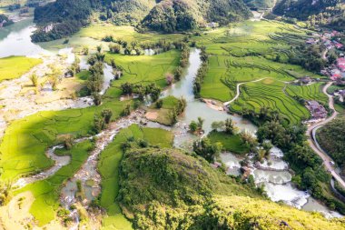 Aerial landscape in Quay Son river, Trung Khanh, Cao Bang, Vietnam with nature, green rice fields and rustic indigenous houses. Travel and landscape concept clipart