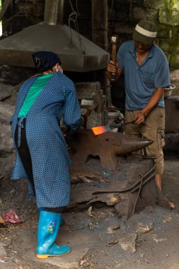 Cao Bang Province, Vietnam - February 24, 2024: Blacksmith makes a traditional rural knife in Cao Bang province, Vietnam clipart