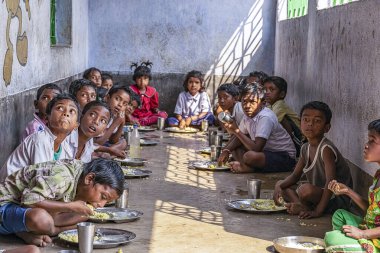 Children siting to eat Unicef midday meal program run for upto 15yrs children in schools. February, Asansol, India. 2017.