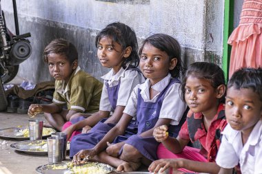 Children siting to eat Unicef midday meal program run for upto 15yrs children in schools. February, Asansol, India. 2017.