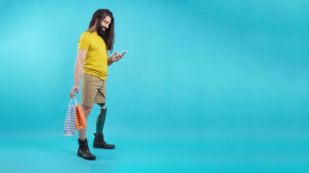 Studio Video Blue Background Cool Man Prosthetic Leg Using Mobile — Vídeo de Stock