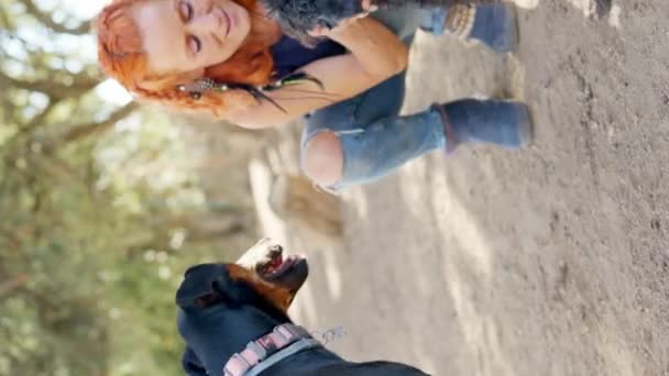 Vertical Video Caucasian Woman Squatting Petting Dogs Park — Stock Video