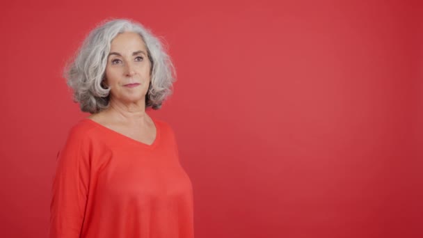 Studio Video Red Background Happy Mature Woman Receiving Gift — стоковое видео