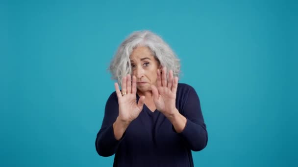 Studio Video Blue Background Mature Woman Who Very Afraid — Vídeo de Stock