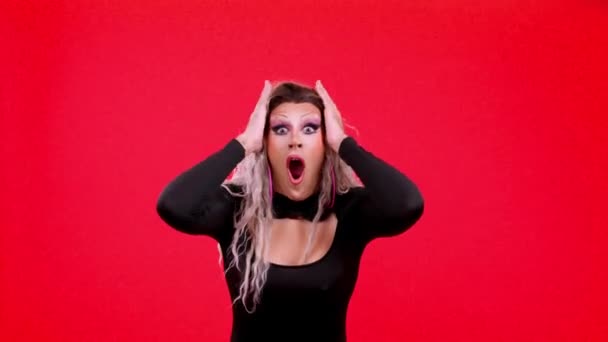 Surprised Transgender Person Gesturing Hands Fear Studio Red Background — Stockvideo