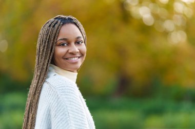 Photo with copy space of an african woman turning to smile at the camera