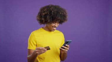 African man using a card to shopping online with the mobile in studio