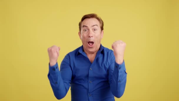 Happy Mature Man Celebrating Raising Fists Studio Yellow Background — Stok video
