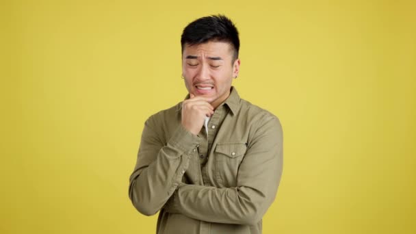 Worried Chinese Man Looking Pensive Expression Studio Yellow Background — Video