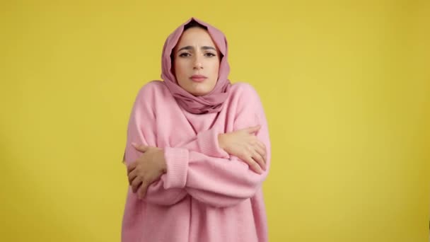 Moslim Vrouw Kijken Naar Camera Kou Studio Met Gele Achtergrond — Stockvideo