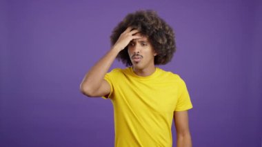 Desperate african man gesturing that he is forgetting something in studio