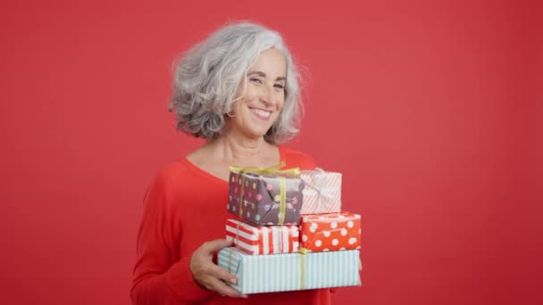 Studio Video Red Background Excited Mature Woman Receiving Many Gifts — Vídeo de Stock
