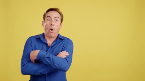 Happy Mature Man Looking Aside Arms Crossed Studio Yellow Background — Video