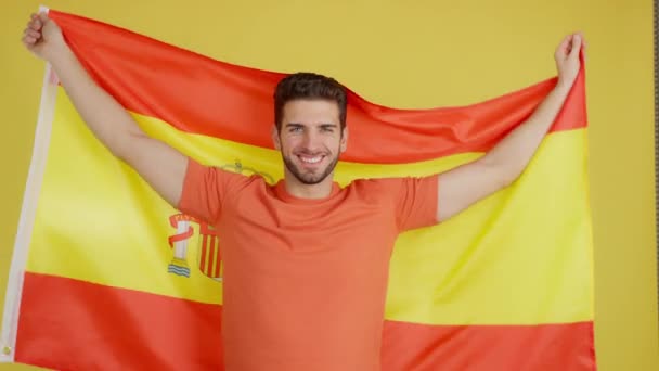 Happy Caucasian Man Smiling Raising Spanish National Flag Studio Yellow — Stockvideo
