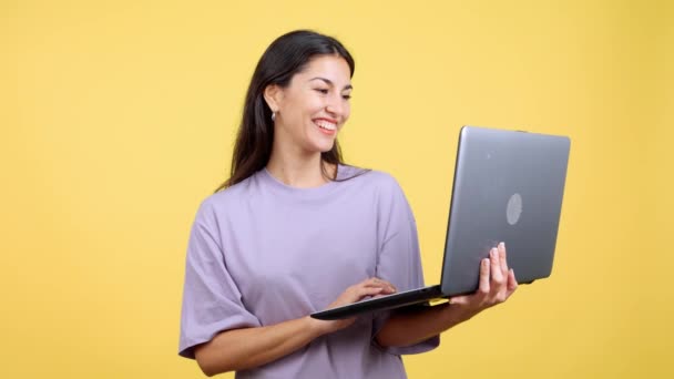 Caucasian Woman Smiling While Using Laptop Studio Yellow Background — Vídeo de Stock