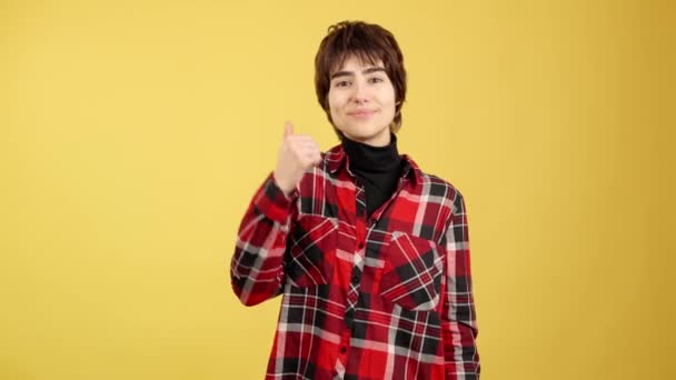 Androgynous Person Gesturing Approval Thumb Studio Yellow Background — Video