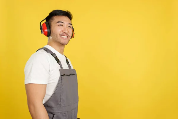 Chinese Carpenter Smiling Distracted While Looking Wearing Protective Gear Headphones — Stock Photo, Image