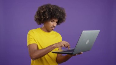 African man with a laptop gesturing that there is a problem in studio