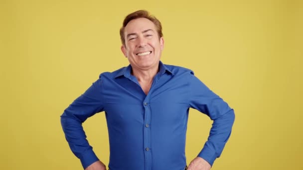 Mature Man Laughing While Standing Arms Crossed Studio Yellow Background — Wideo stockowe