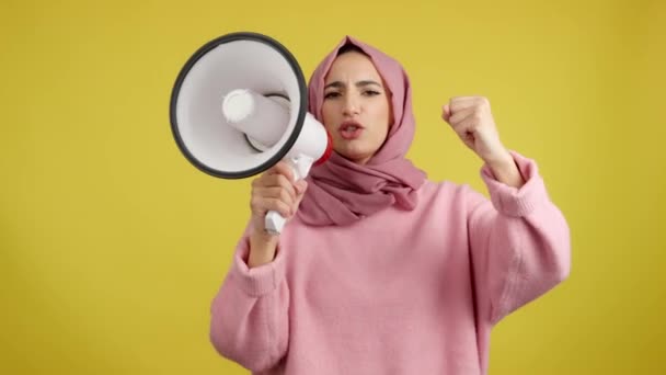 Arg Muslimsk Kvinna Skriker Med Högtalare Studio Med Gul Bakgrund — Stockvideo