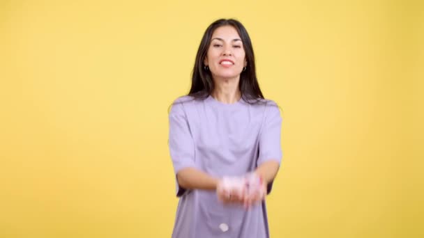 Happy Woman Surrounded Confetti Flying Air Studio Yellow Background — Vídeo de Stock
