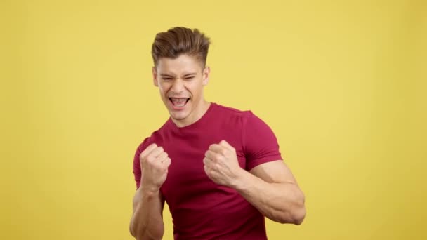 Man Brackets Celebrating Fists Raised Studio Yellow Background — Stock Video