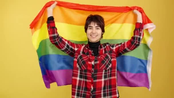 Androgynous Person Raising Lgbt Rainbow Flag Studio Yellow Background — Stock Video