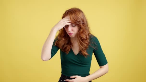 Redheaded Woman Gesturing Bodily Discomfort Headache Studio Yellow Background — Stock Video