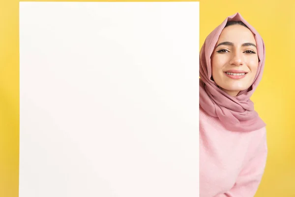 Happy Muslim Woman Holding Blank Panel Studio Yellow Background — Stock Photo, Image