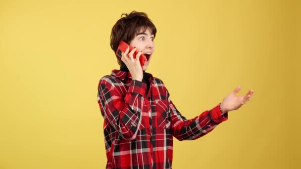 Stüdyoda Sarı Arka Planda Cep Telefonuyla Konuşan Androgynous Kişi — Stok video