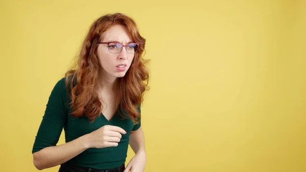 Redheaded Woman Glasses Spying Curiosity Studio Yellow Background — Stock Photo, Image