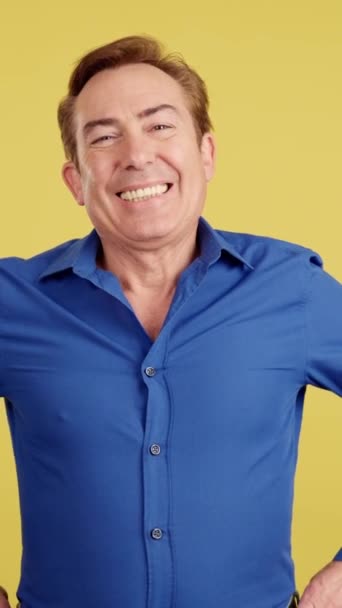 Mature Man Laughing While Standing Arms Crossed Studio Yellow Background — Vídeo de Stock