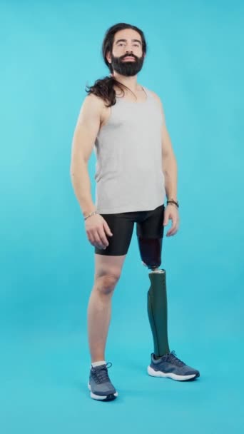 Studio Βίντεο Μπλε Φόντο Ενός Χαμογελαστού Άνδρα Στέκεται Ένα Πόδι — Αρχείο Βίντεο