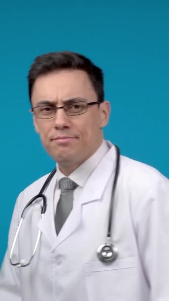 Beyaz Cüppeli Steteskoplu Tatmin Olmuş Erkek Doktor Gülümsüyor Mavi Arka — Stok video